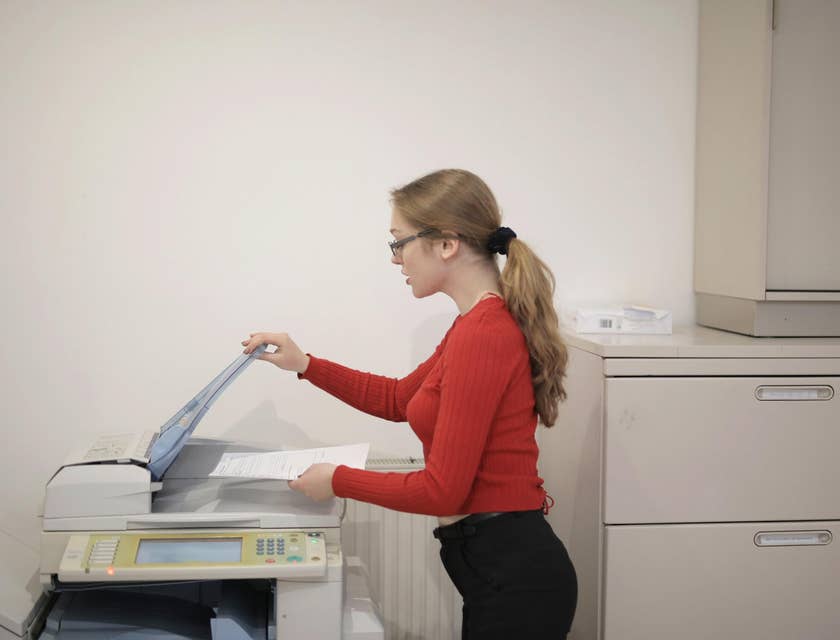 Administrative Secretary assisting with scanning a document.