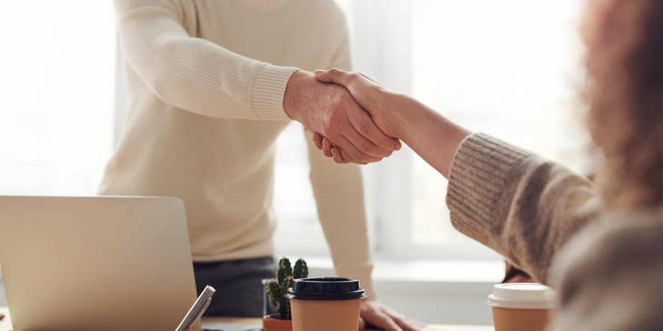 Assistant Manager shaking hands with the newly hired employee