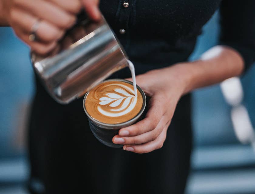 Barista showing exceptional latte art skill.