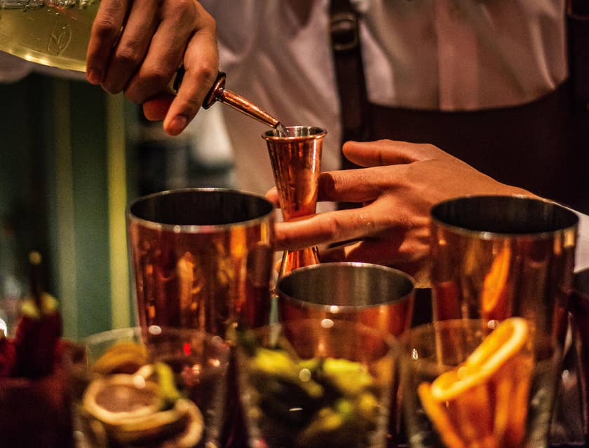 Bartender mixes alcoholic beverages as per customers request.