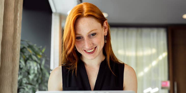 A woman researching the best remote job boards.