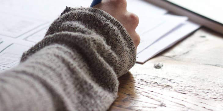 A person writing a reference letter.