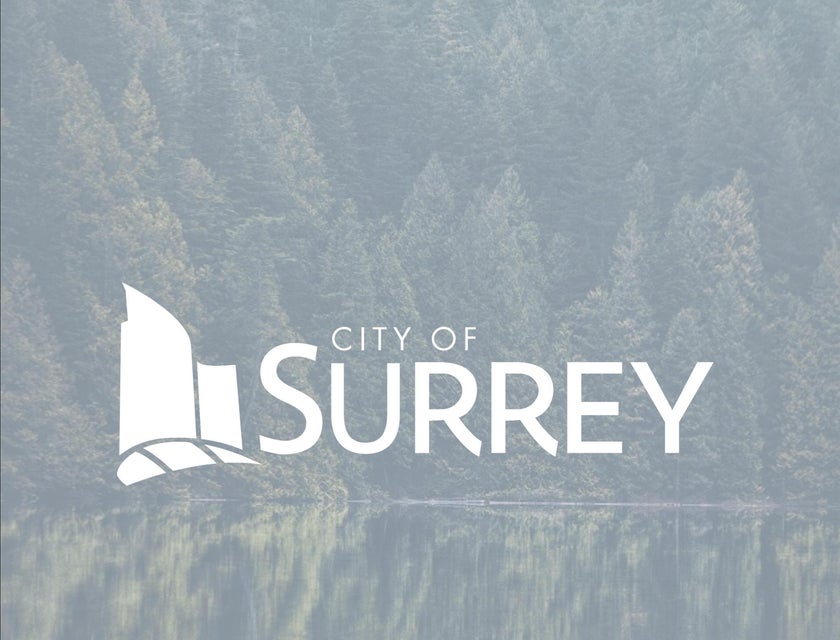 The City of Surrey logo against a backdrop of trees and a lake in British Columbia.