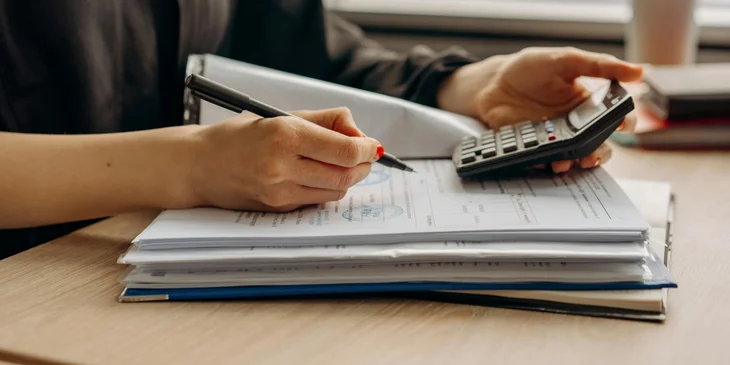 Una contadora trabajando usando una calculadora.