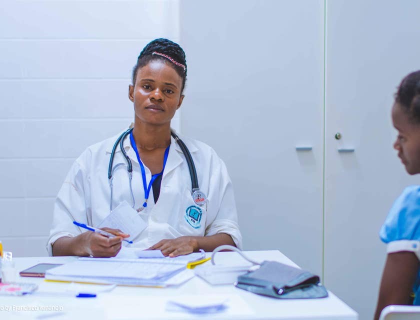 A general practitioner assessing a young patient.