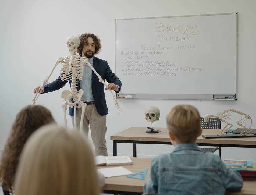 Biology Teacher explaining human anatomy to his students in a classroom