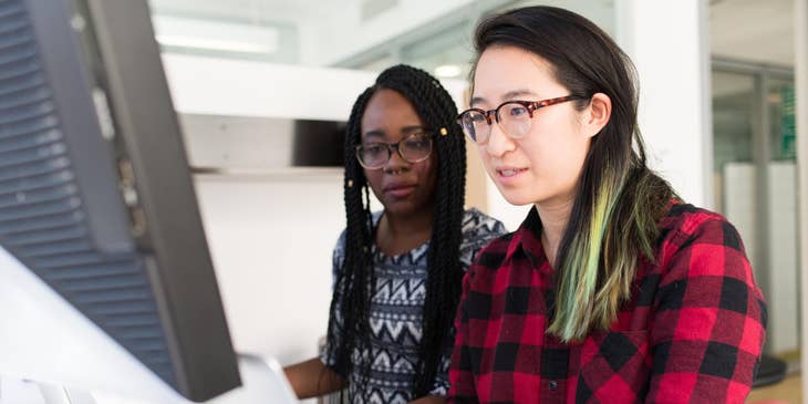 Business Development Specialist teaching client on how to use computer for business growth