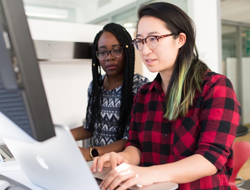 Business Development Specialist teaching client on how to use computer for business growth