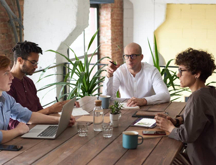 Business Intelligence Analyst sits with his team to compare business data