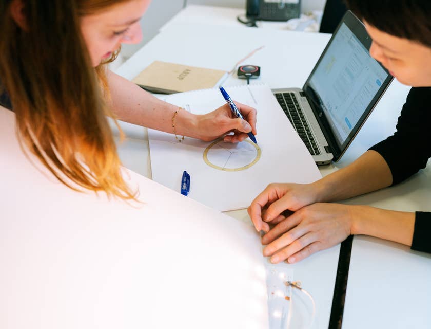 CAD Designer sketching a new model design with her colleague