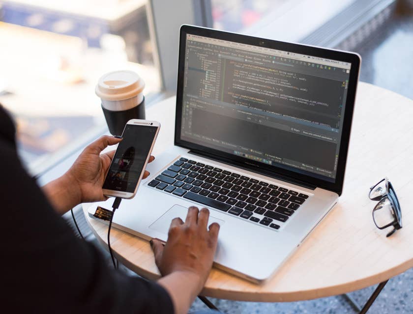 CNC Programmer interpreting codes while browsing on a phone
