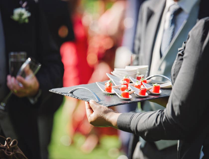The Caterer provides food at a social gathering.