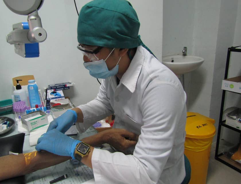 Certified Medical Assistant is taking blood from a patient for diagnosis