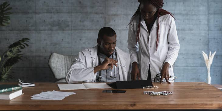 Clinical Professor discussing academic data to a healthcare specialist