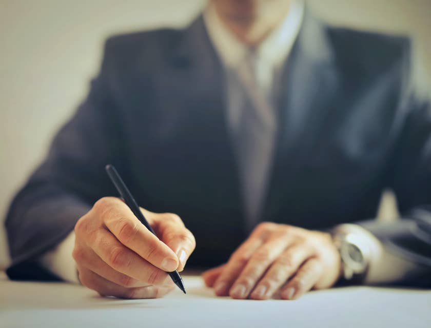 A Country Manager writing on a paper.