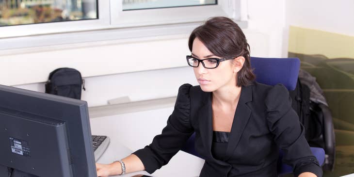 Executive Administrative Assistant typing on a computer
