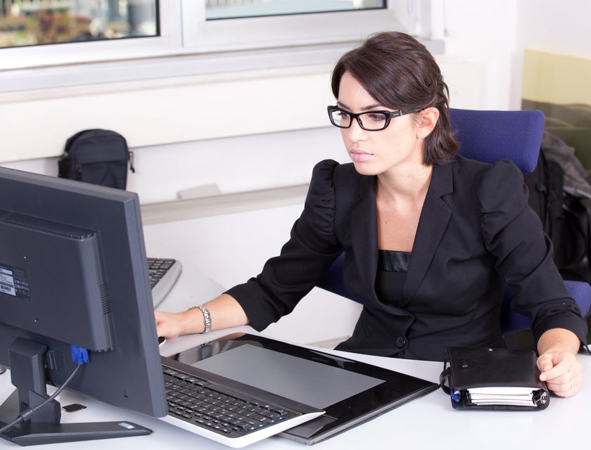 Executive Administrative Assistant typing on a computer