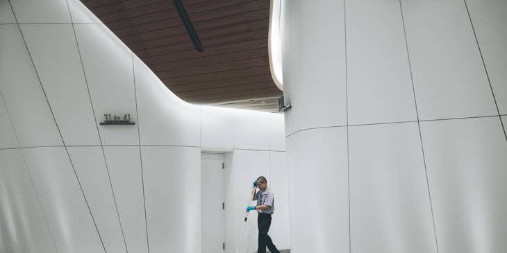 Facilities Manager cleaning floors in a building
