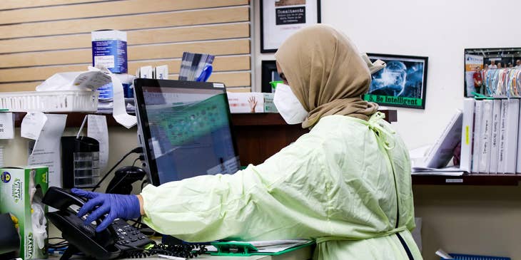 Healthcare Administrator in front of a desktop about to make a call