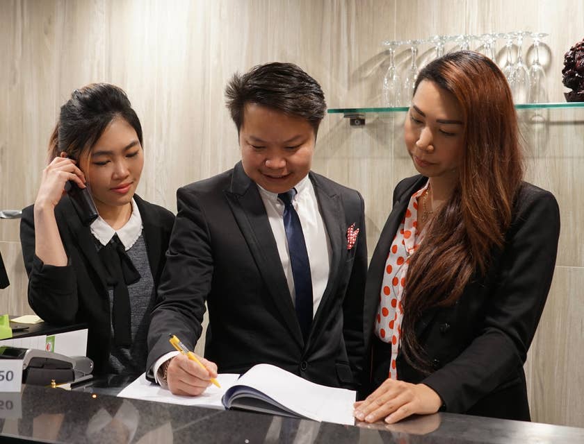 A hotel manager discussing to his staff.
