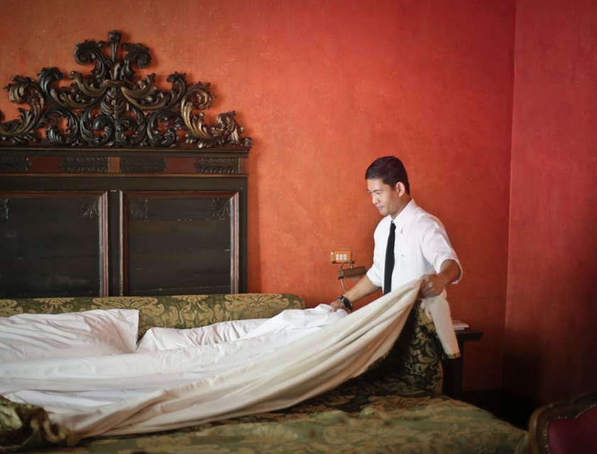 A housekeeper fixing the sheets.