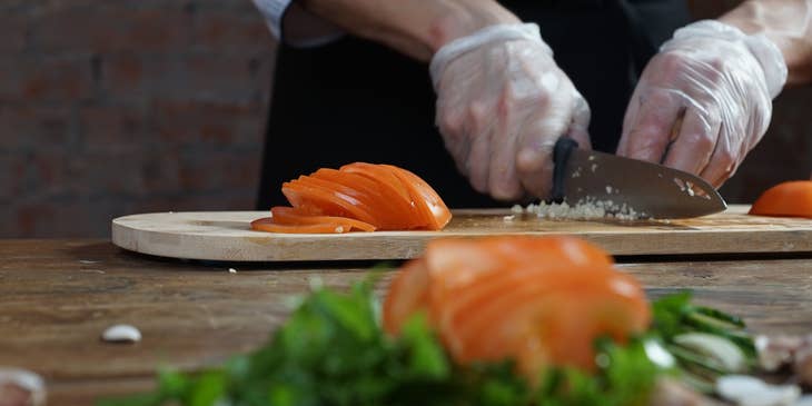 A lead line cook preparing ingredients.