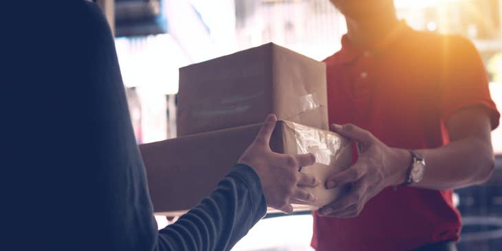 Mail Clerk delivering a package to a women in a building