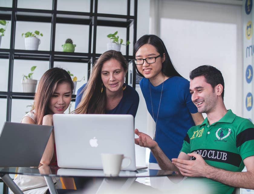 Four developers discussing what they see on a laptop's screen