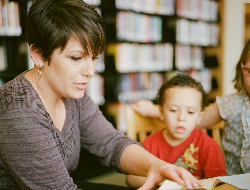Paraprofessional is telling a story to a group of young students