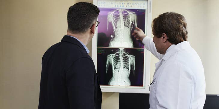 Pediatric geneticist explaining lung condition to the patient's patient while showing Xray results