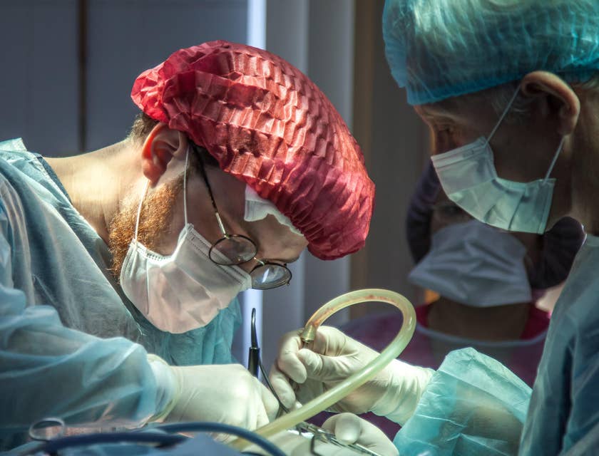 Pediatric surgeon carefully operating on a young patient with his assistant