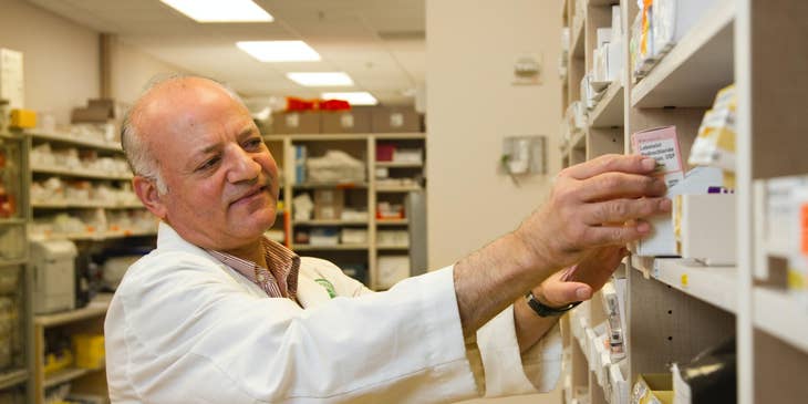 Pharmacist accurately checks the medicine on the shelf