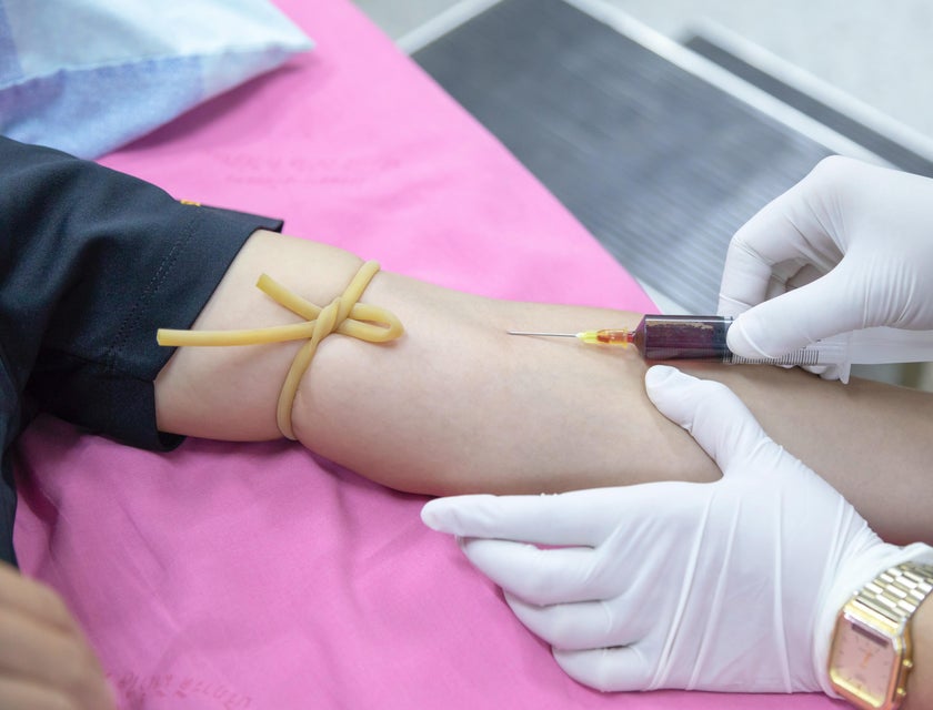 Phlebotomy technician extracts blood from the patient for blood donation