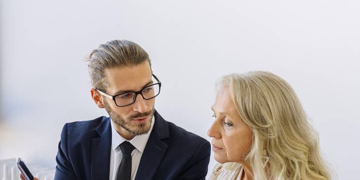 Policy analyst meeting his client and providing information on new policies to their business.