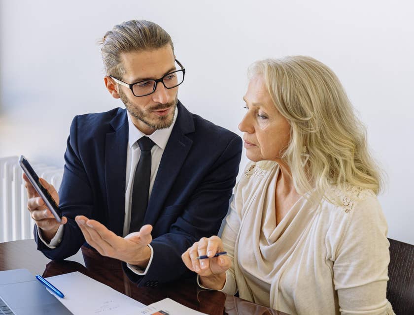 Policy analyst meeting his client and providing information on new policies to their business.