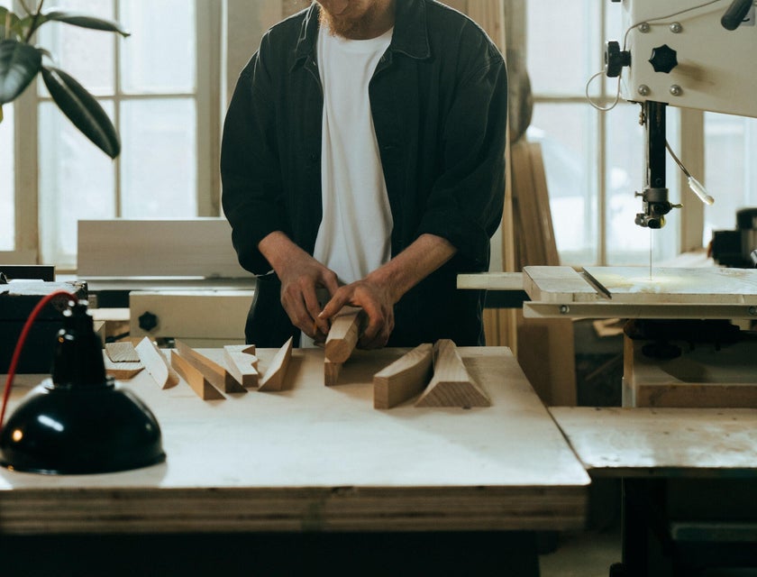 Product designer working on a new project while checking his wood designs