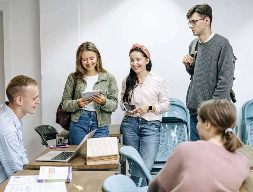 Professor meeting checking research work on a laptop with a group of college students