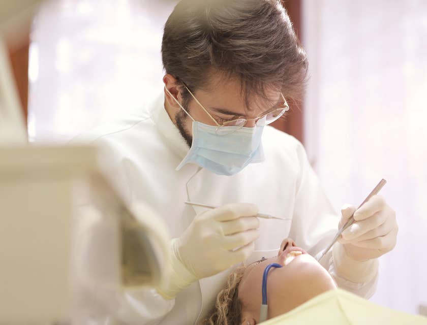 Prosthodontist performs dental implants on a patient