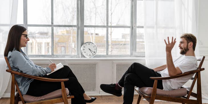 Psychologist listens to the patient's concerns while taking notes on possible treatment plans