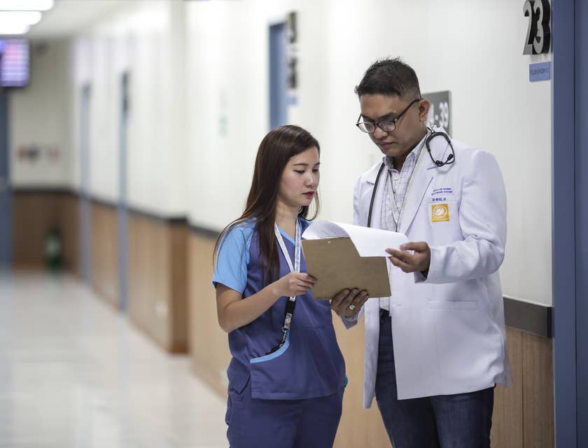 Public Health Nurse listens to direction by the doctor on patient care as they wait for patients