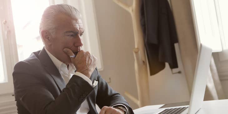 Reporting analyst thinking on new ideas based on data on his computer