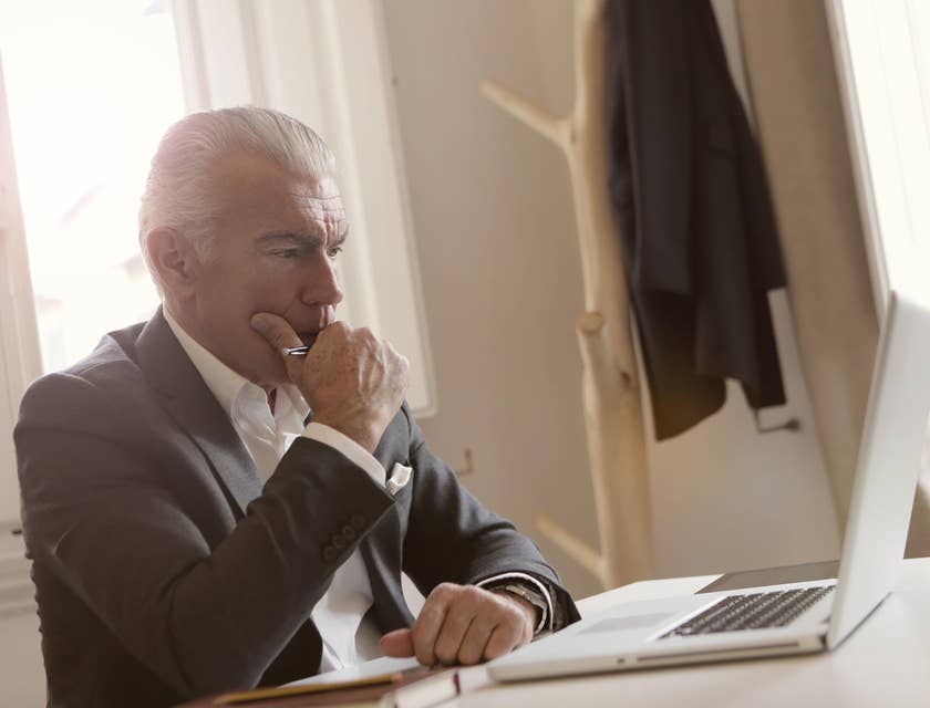 Reporting analyst thinking on new ideas based on data on his computer