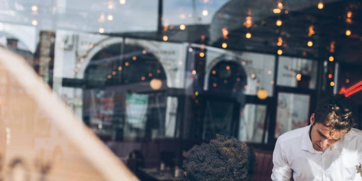 A restaurant server taking a customers order.