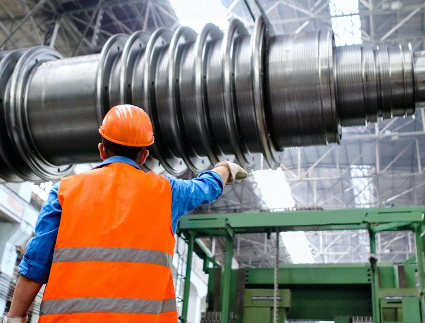 Safety Coordinator checks the machine in a workplace to ensure safety in the workplace
