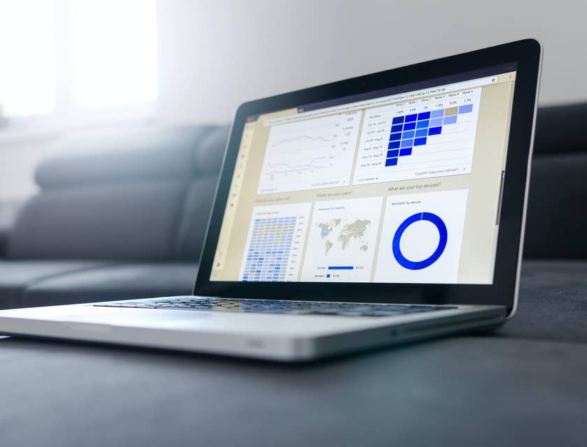 Salesforce business analysts workstation with data and graphs displayed on a laptop's screen