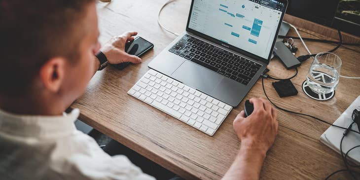 A Salesforce developer working on his laptop