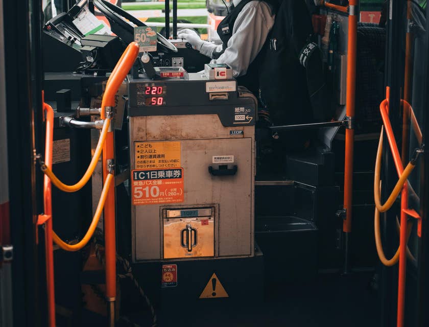 School bus driver waits for students on a bus wearing a protective mask