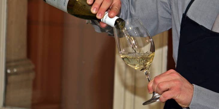 A sommelier preparing wine.