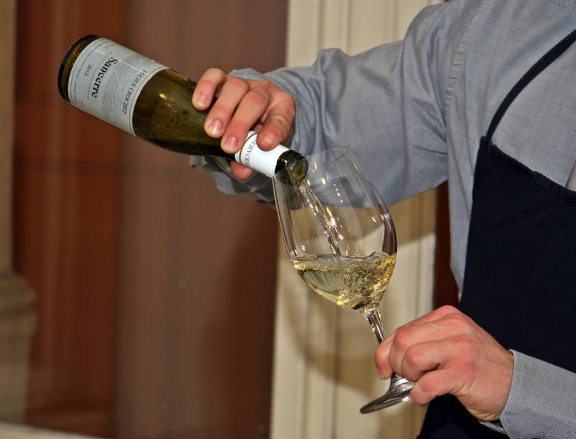 A sommelier preparing wine.