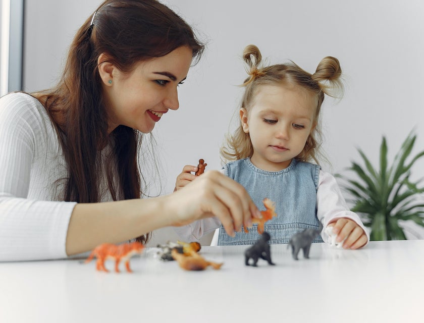 Speech language pathologist helping a toddler identify animals during a therapy session